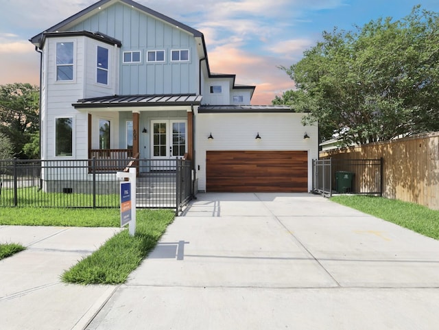 603 Neyland St, Houston, TX 77022 - view of front facade featuring board and batten siding, a fenced front yard, driveway, an attached garage, and covered porch