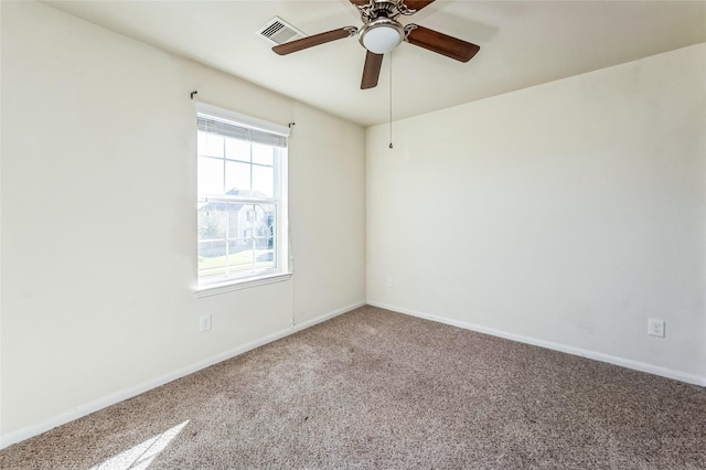 carpeted empty room with visible vents, baseboards, and ceiling fan