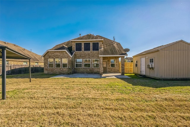 rear view of property with a patio area, fence, brick siding, and a yard