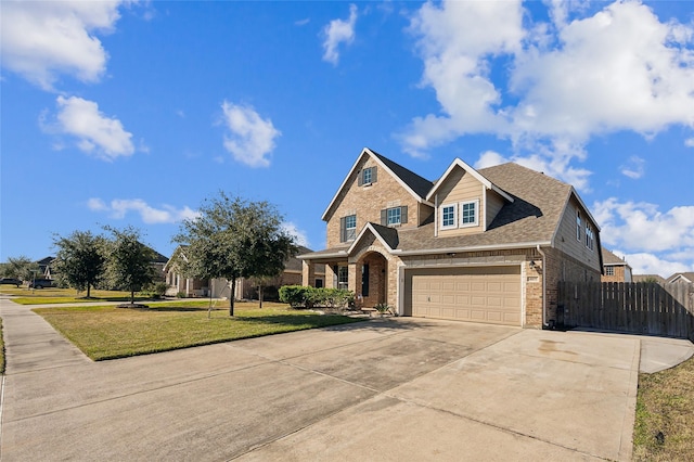 craftsman-style home featuring an attached garage, fence, brick siding, a front lawn, and driveway
