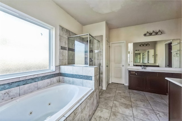 bathroom featuring a shower stall, tile patterned flooring, a jetted tub, and vanity