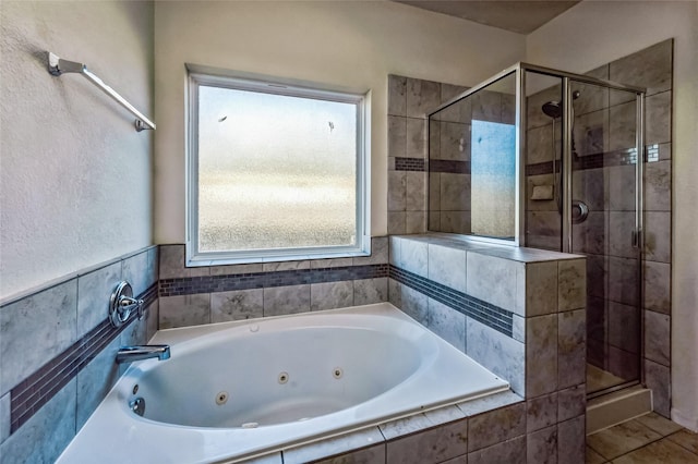 full bath with a shower stall and a jetted tub