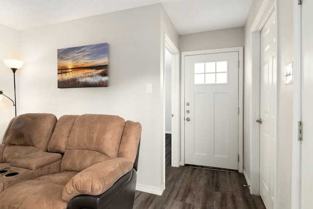foyer featuring baseboards and dark wood finished floors