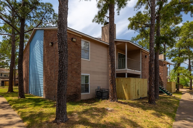 view of home's exterior featuring a chimney and stairs