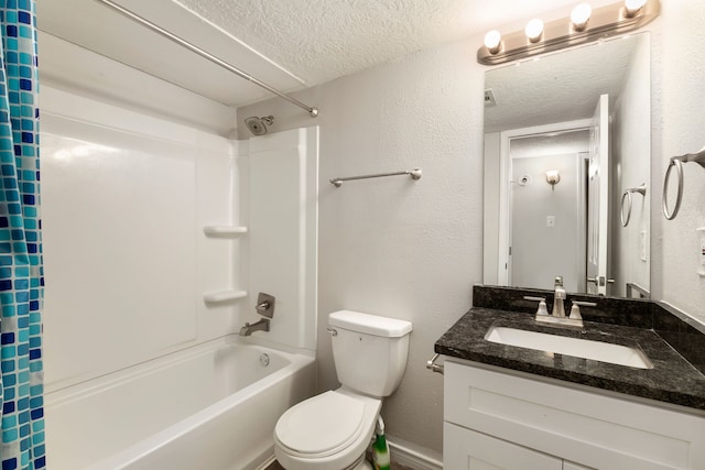 bathroom featuring shower / bath combo, a textured ceiling, toilet, a textured wall, and vanity