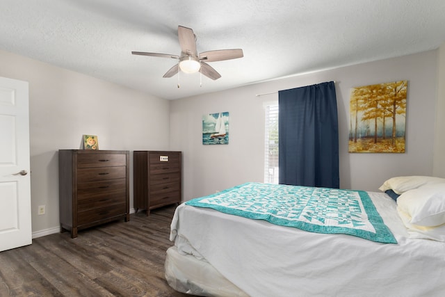 bedroom featuring wood finished floors, baseboards, and ceiling fan