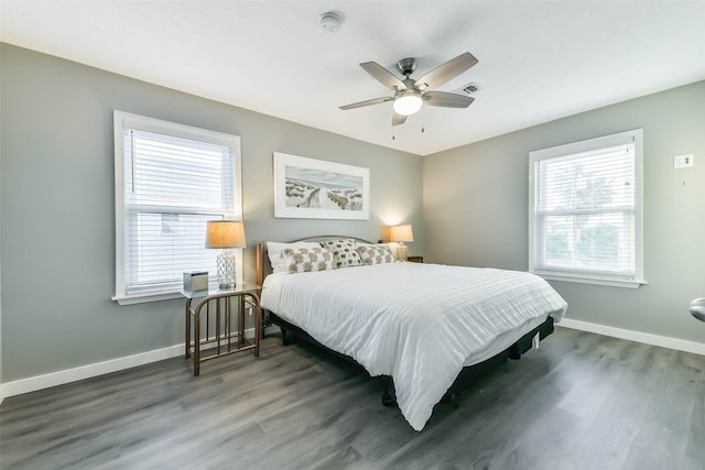bedroom with visible vents, baseboards, a ceiling fan, and wood finished floors