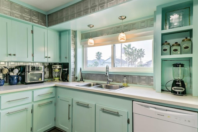 kitchen featuring light countertops, pendant lighting, a sink, and white dishwasher