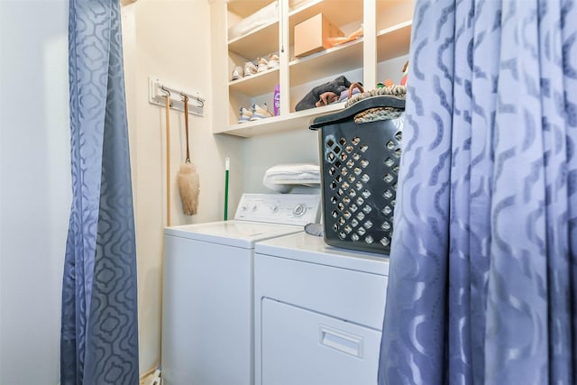 washroom with independent washer and dryer and laundry area
