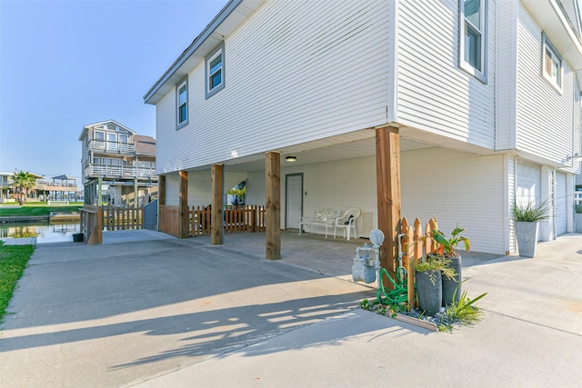 view of side of home featuring a carport and driveway