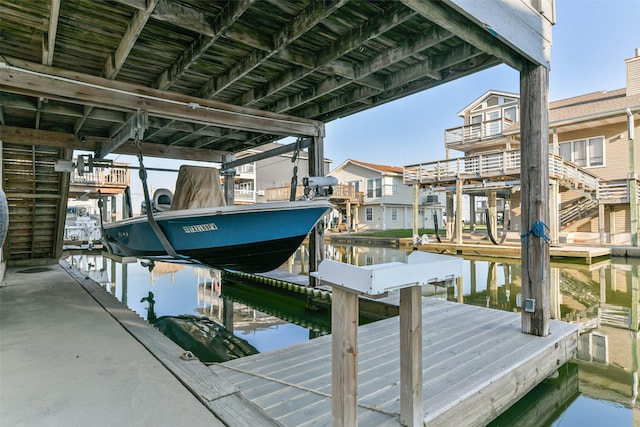 view of dock featuring boat lift and a water view