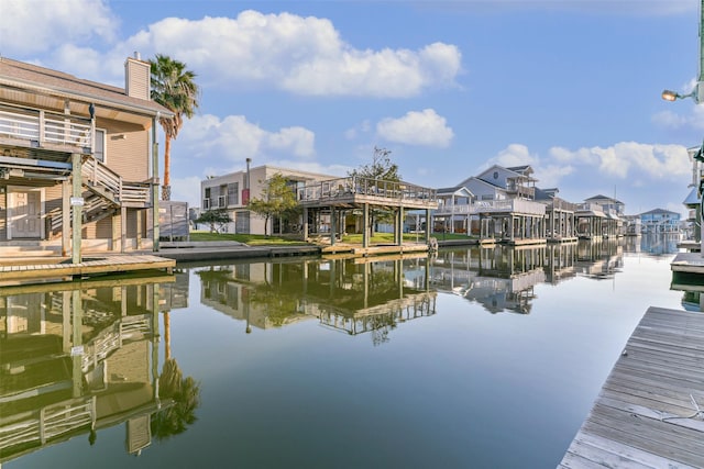 view of dock with a water view and a residential view