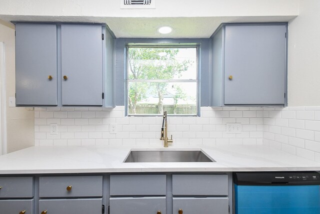 19918 Burle Oak Dr, Humble, TX 77346 - kitchen featuring tasteful backsplash, a sink, light countertops, dishwashing machine, and gray cabinetry