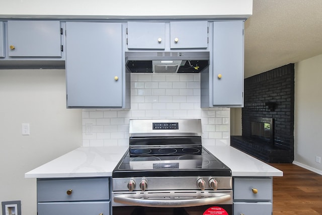 19918 Burle Oak Dr, Humble, TX 77346 - kitchen featuring stainless steel electric range, under cabinet range hood, dark wood-style floors, and gray cabinets