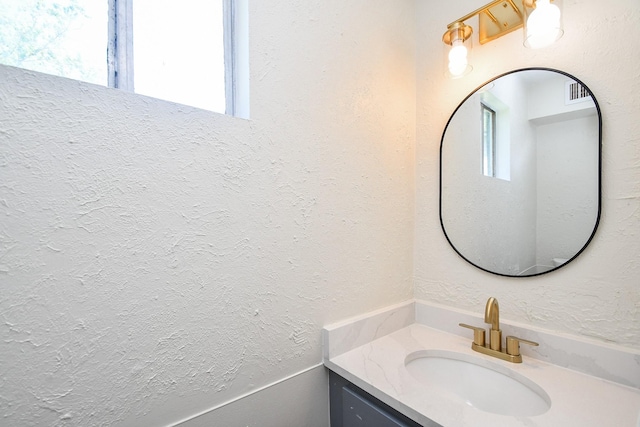 19918 Burle Oak Dr, Humble, TX 77346 - bathroom with vanity, a textured wall, and visible vents