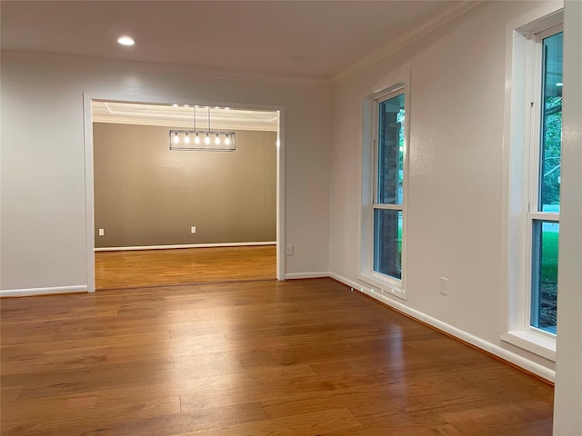 unfurnished room featuring baseboards, wood finished floors, recessed lighting, and ornamental molding