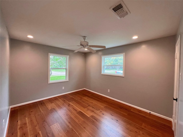unfurnished room with plenty of natural light, visible vents, and baseboards