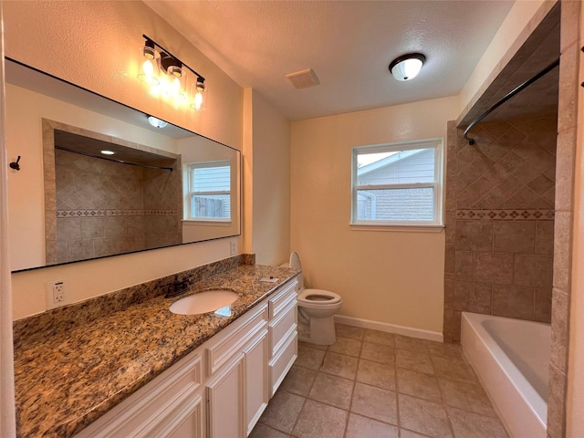 bathroom with toilet, baseboards, visible vents, vanity, and shower / tub combination