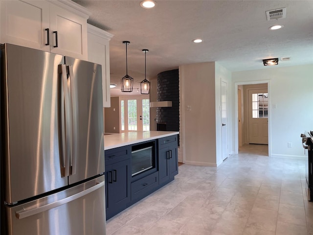 5475 Jackwood St, Houston, TX 77096 - kitchen with freestanding refrigerator, light countertops, white cabinetry, baseboards, and recessed lighting