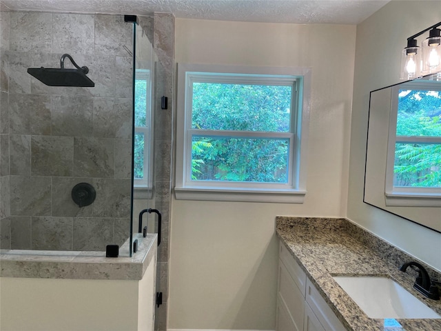 5475 Jackwood St, Houston, TX 77096 - bathroom with a stall shower, plenty of natural light, vanity, and a textured ceiling