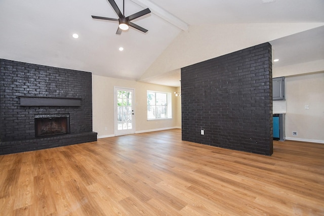 19919 Burle Oak Dr, Humble, TX 77346 - unfurnished living room with light wood-style flooring, beamed ceiling, ceiling fan, and a fireplace
