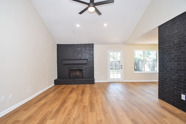 19919 Burle Oak Dr, Humble, TX 77346 - unfurnished living room with a fireplace, light wood-type flooring, a ceiling fan, vaulted ceiling, and baseboards