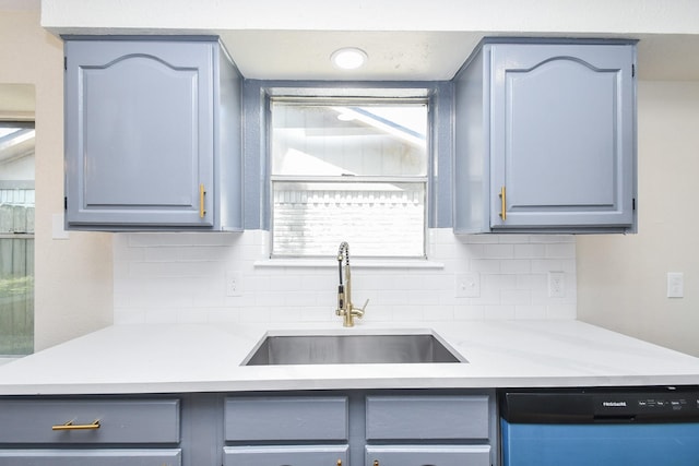 19919 Burle Oak Dr, Humble, TX 77346 - kitchen featuring gray cabinets, decorative backsplash, a sink, and dishwashing machine