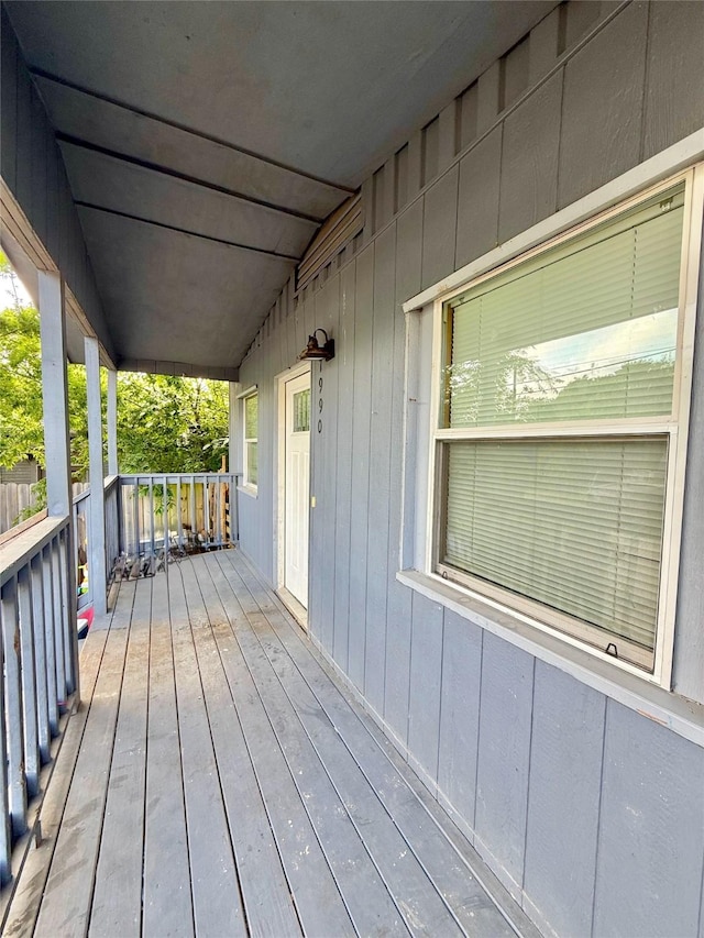 wooden terrace featuring covered porch