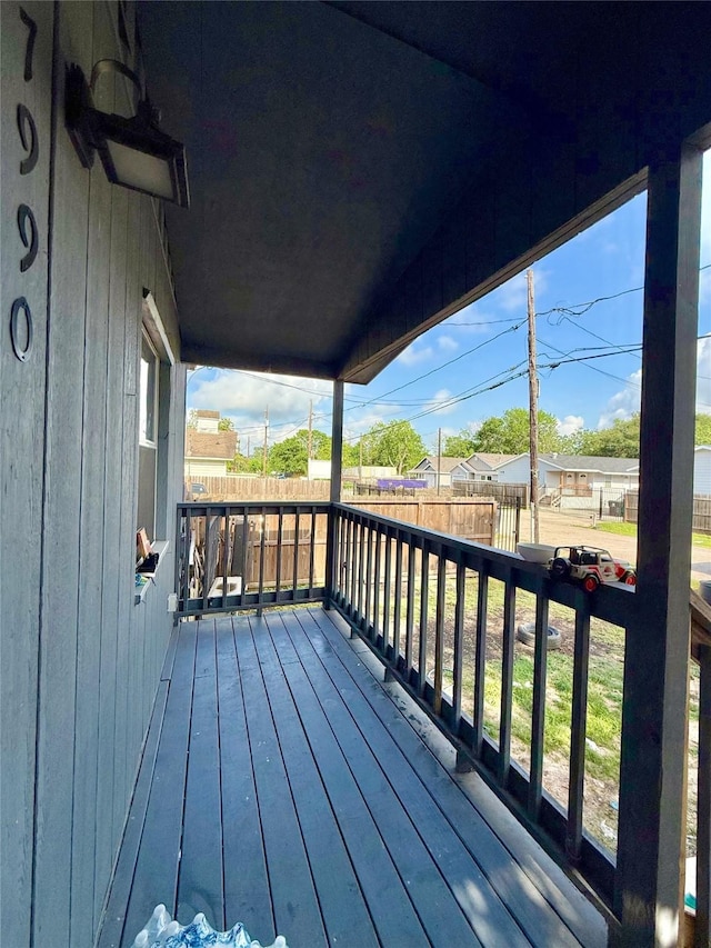 wooden terrace featuring fence