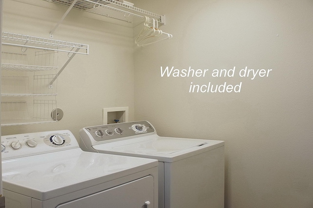 clothes washing area featuring independent washer and dryer and laundry area