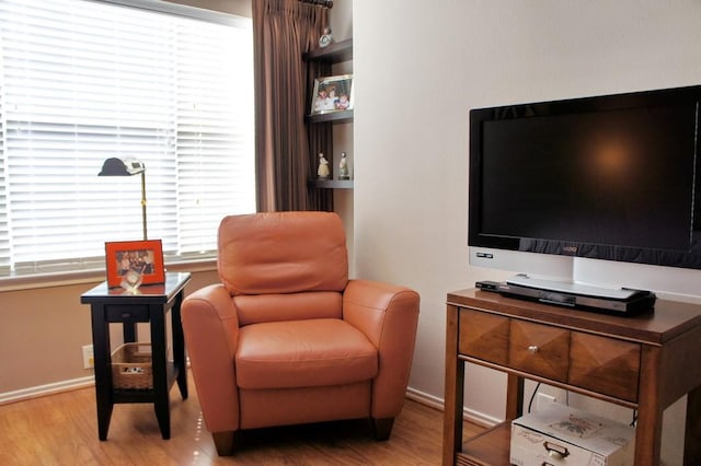 sitting room featuring baseboards and wood finished floors