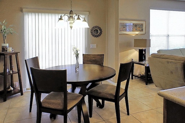 dining space with a chandelier and light tile patterned floors