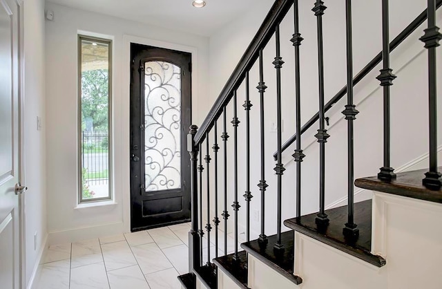 entrance foyer featuring baseboards, recessed lighting, marble finish floor, and stairs