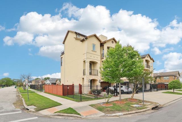 view of building exterior with fence and a residential view