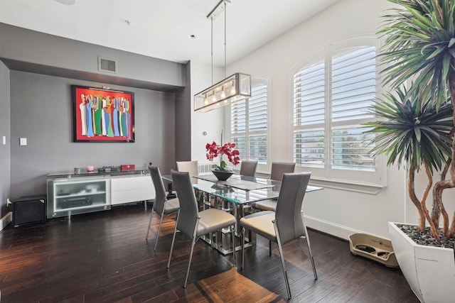 dining area with visible vents, baseboards, and wood finished floors