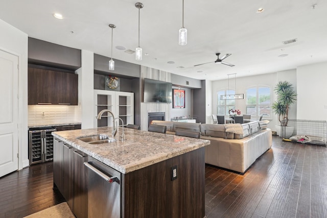 kitchen with visible vents, a sink, a ceiling fan, dark brown cabinetry, and wine cooler
