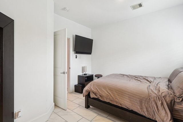 bedroom featuring marble finish floor and visible vents