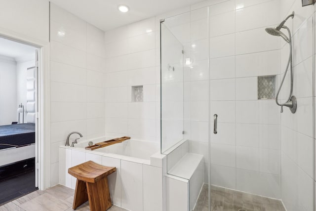 ensuite bathroom featuring a shower stall, recessed lighting, ensuite bath, and a garden tub
