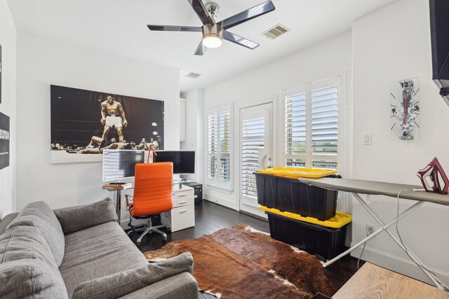 office area featuring visible vents, hardwood / wood-style floors, and a ceiling fan
