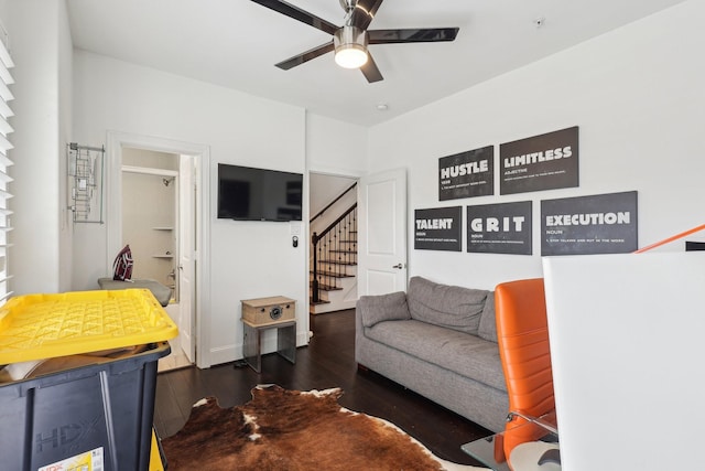 living room featuring stairway, wood finished floors, and a ceiling fan