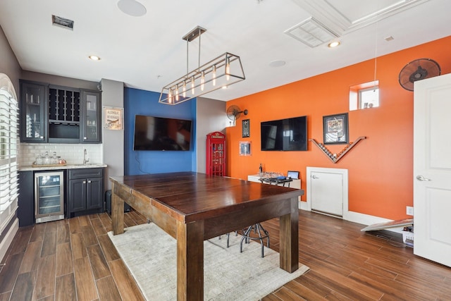 interior space with wine cooler, attic access, dark wood-type flooring, and indoor wet bar