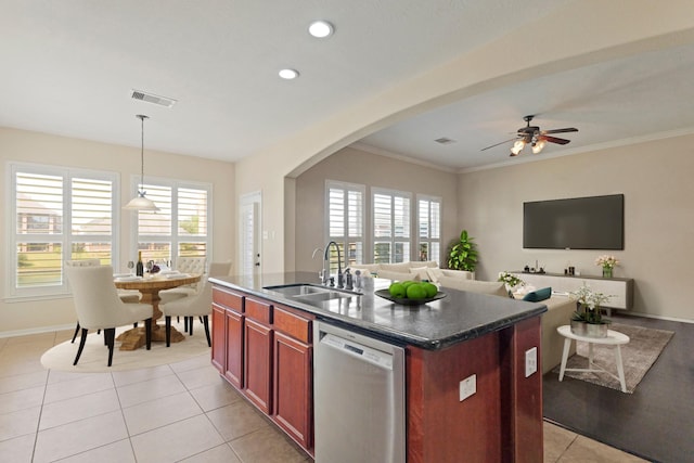 kitchen featuring dark countertops, visible vents, a healthy amount of sunlight, dishwasher, and a sink