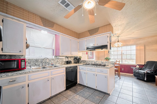 5622 Sheraton Oaks Dr, Houston, TX 77091 - kitchen featuring a sink, dishwasher, under cabinet range hood, gas cooktop, and light countertops