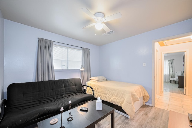 5622 Sheraton Oaks Dr, Houston, TX 77091 - bedroom with multiple windows, a ceiling fan, light wood-style flooring, and attic access