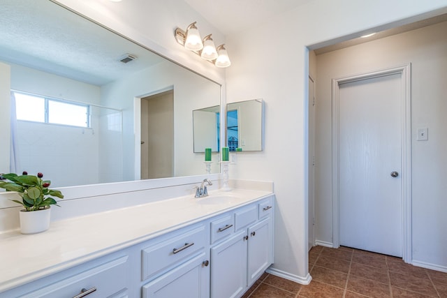 7215 Autumn Day Ct, Magnolia, TX 77354 - bathroom with tile patterned flooring, baseboards, vanity, and visible vents