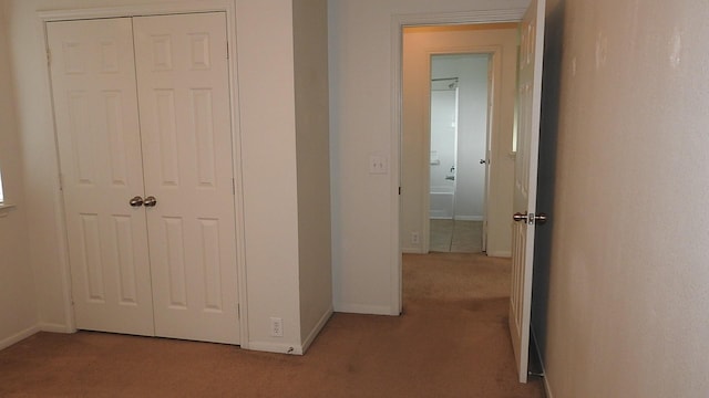 hall featuring baseboards and carpet