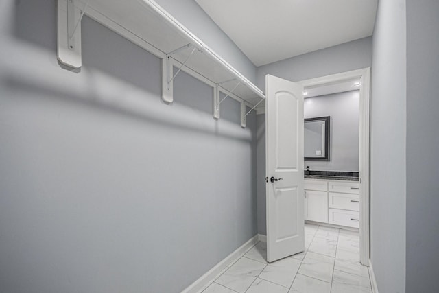 spacious closet with marble finish floor