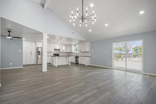 unfurnished living room featuring wood finished floors and baseboards