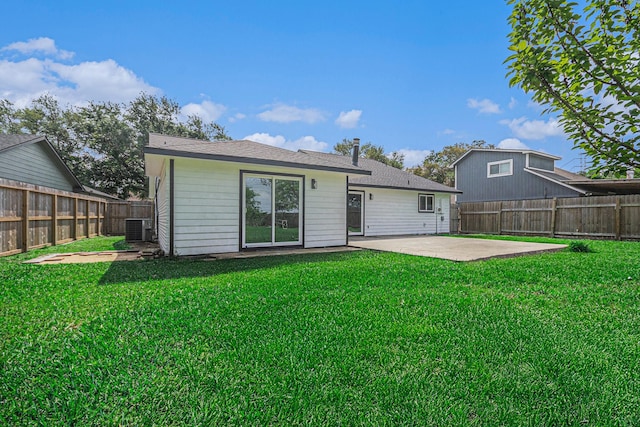 rear view of house featuring a patio, a fenced backyard, a lawn, and central air condition unit