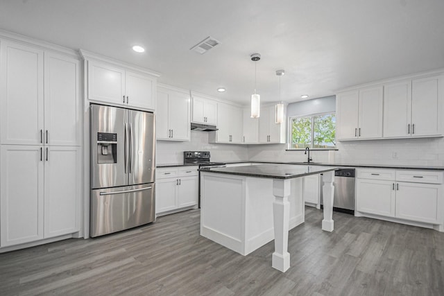 kitchen featuring under cabinet range hood, visible vents, appliances with stainless steel finishes, and white cabinetry